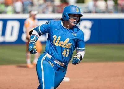 There and back again: UCLA star plays softball, jets to hoops celebration in same day
